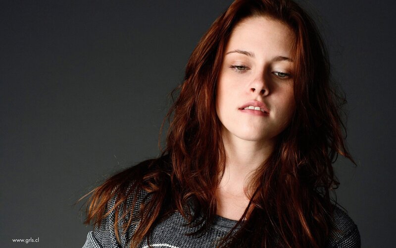 woman with red hair looking down