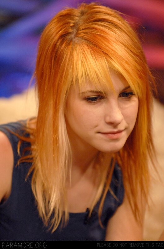 woman with red hair looking down