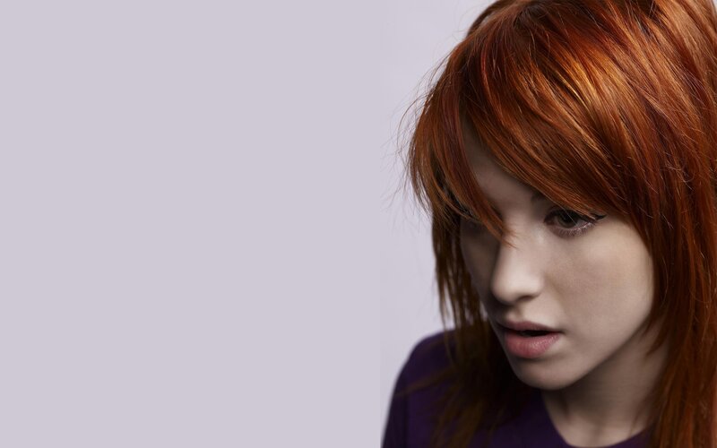 woman with red hair looking down