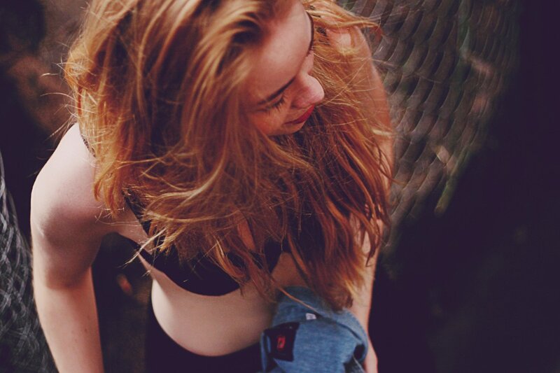 woman with red hair looking down