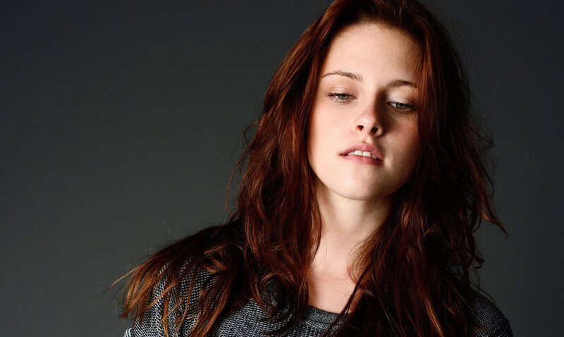 woman with red hair looking down