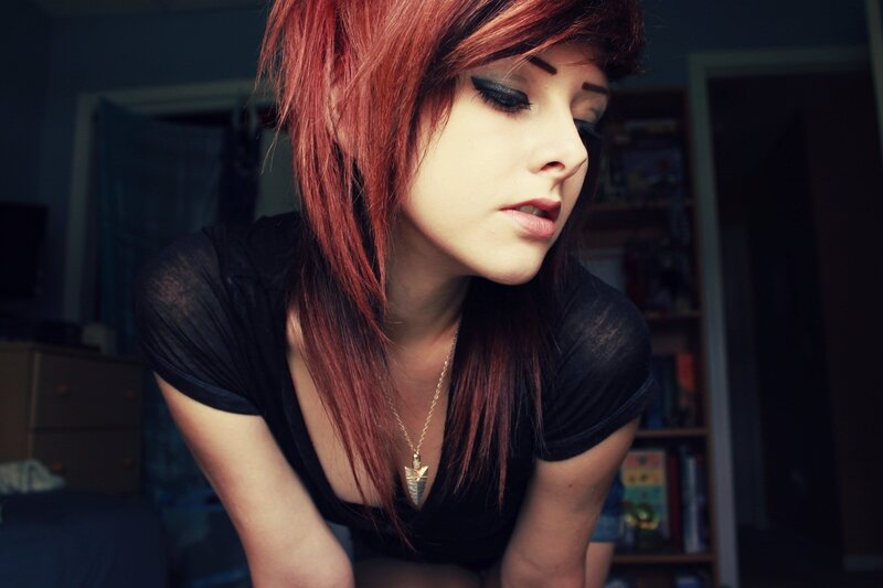 woman with red hair looking down