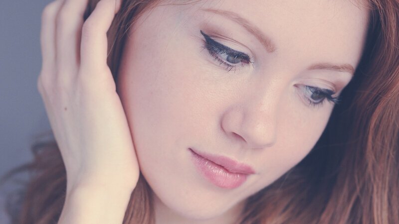 woman with red hair looking down