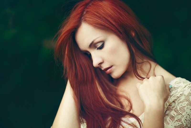woman with red hair looking down