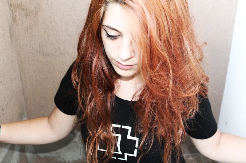 woman with red hair looking down