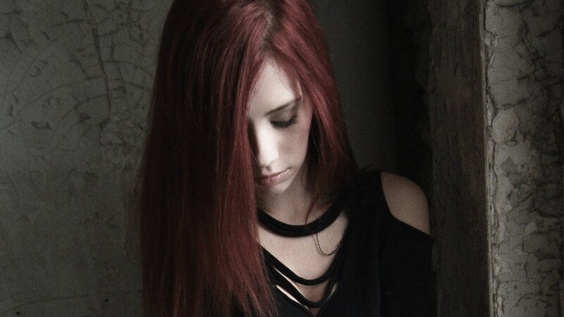 woman with red hair looking down