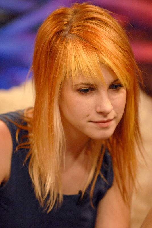 woman with red hair looking down