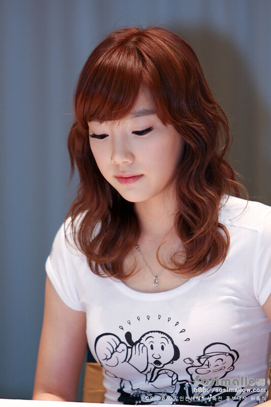 woman with red hair looking down