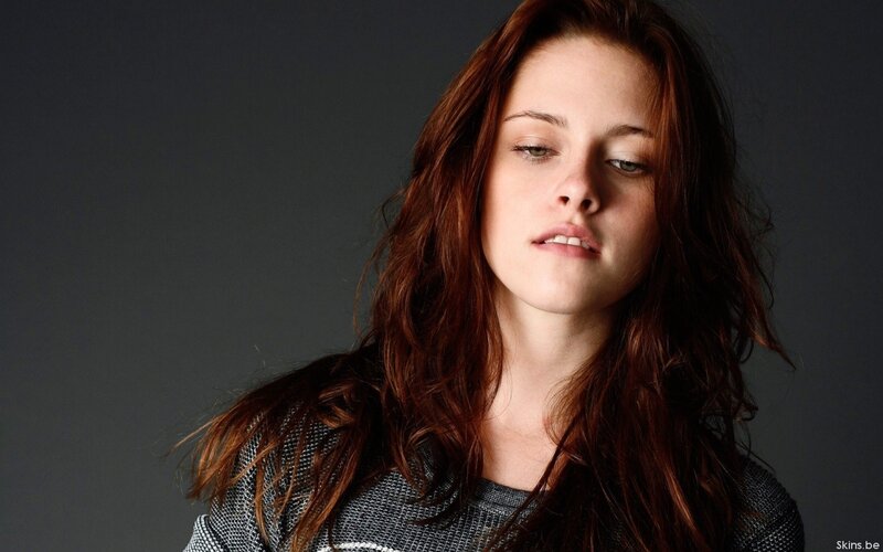 woman with red hair looking down