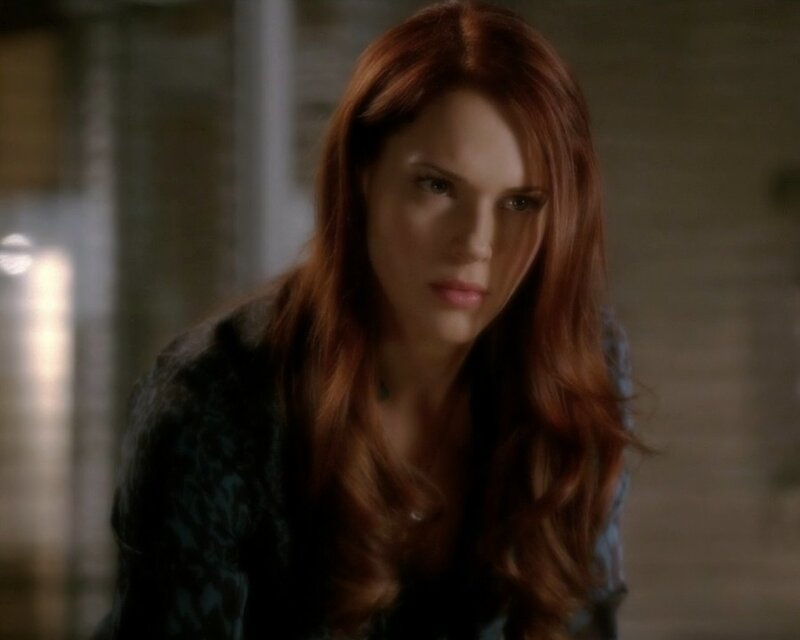 woman with red hair looking down