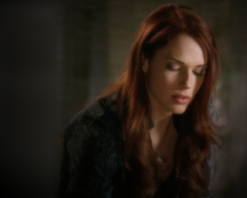 woman with red hair looking down