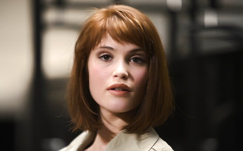 woman with red hair looking forward