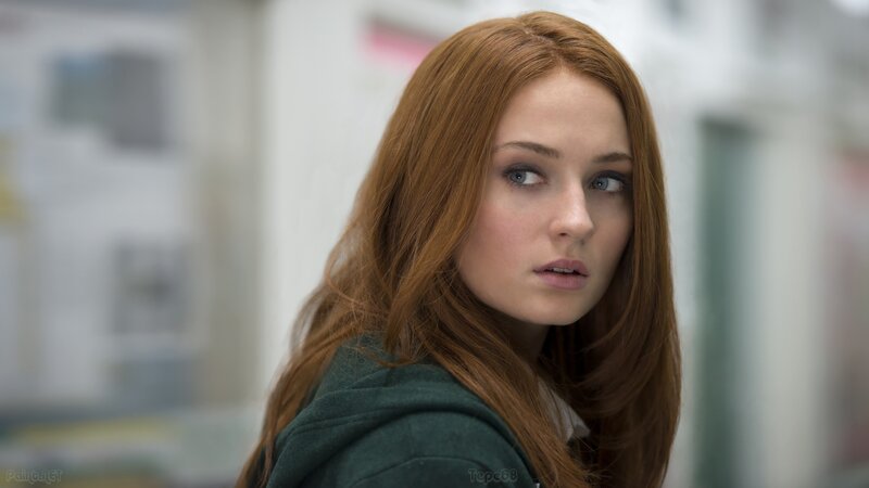 woman with red hair looking over shoulder