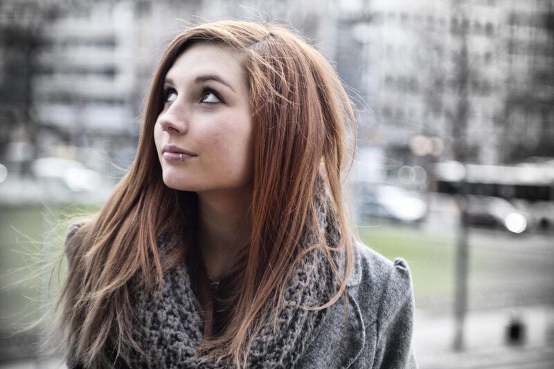 woman with red hair looking up