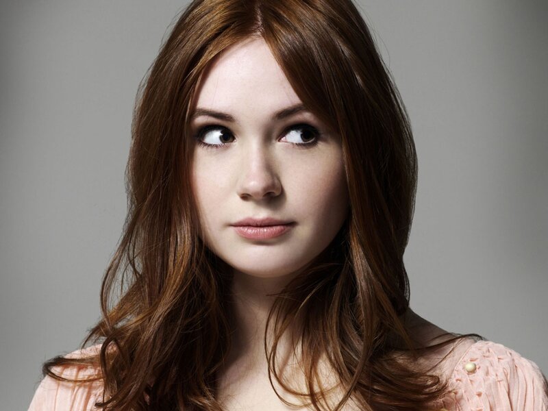 woman with red hair looking up