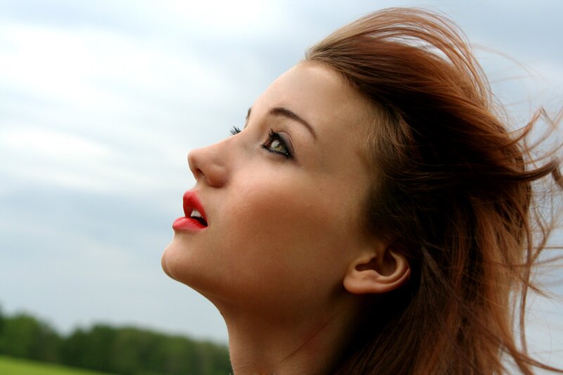 woman with red hair looking up