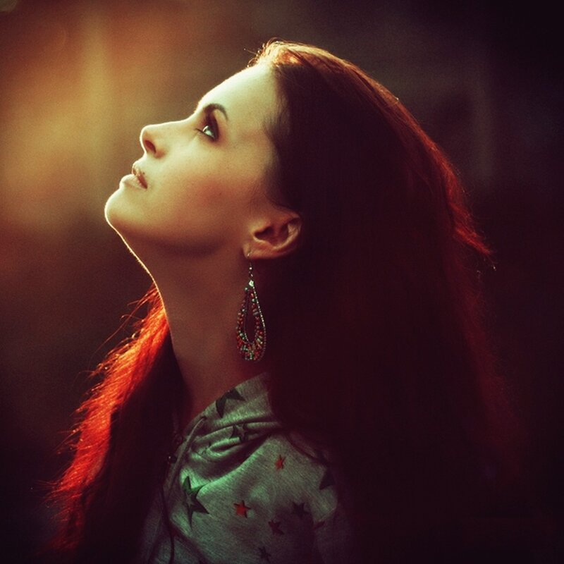 woman with red hair looking up