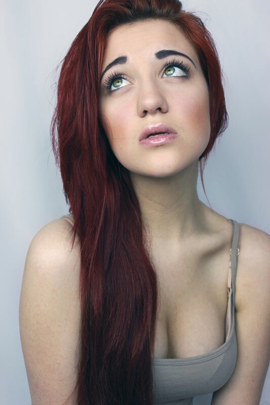 woman with red hair looking up