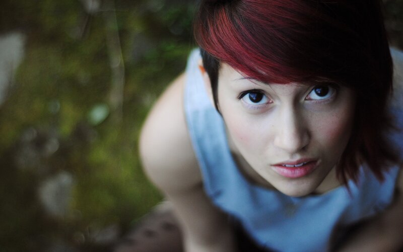 woman with red hair looking up