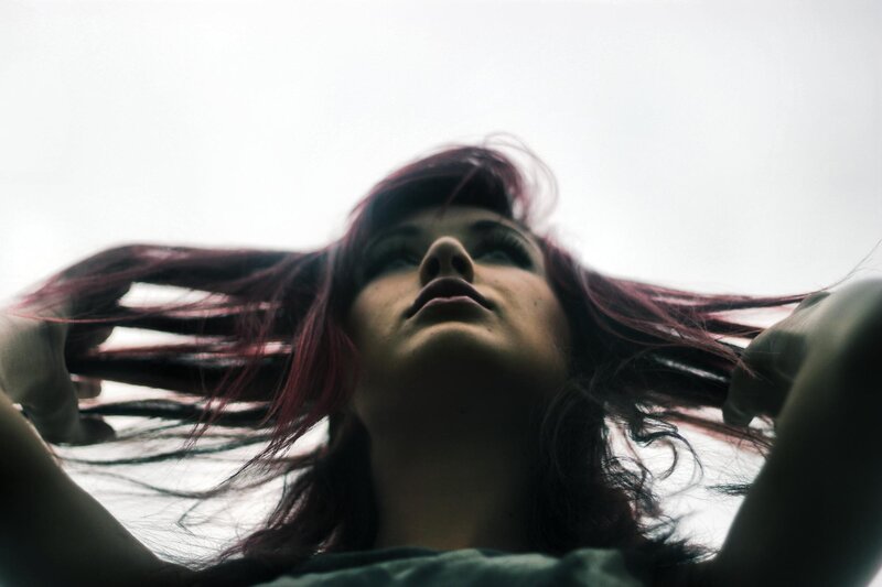 woman with red hair looking up