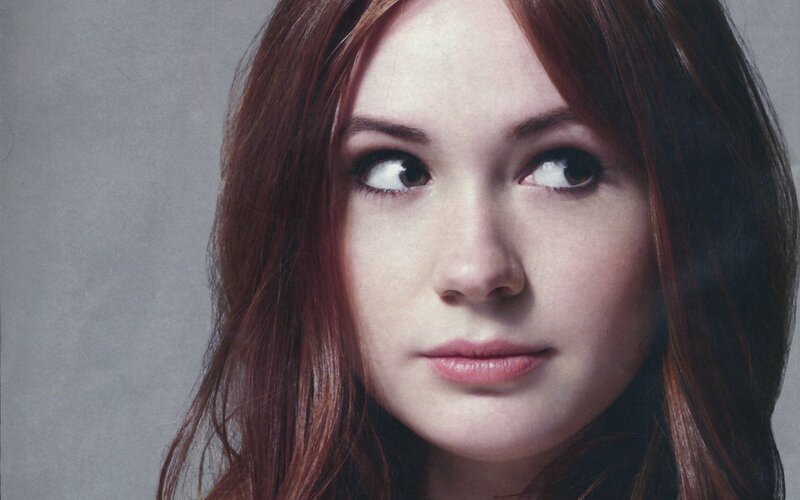 woman with red hair looking up