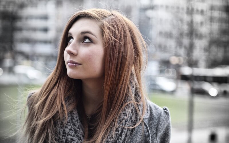 woman with red hair looking up