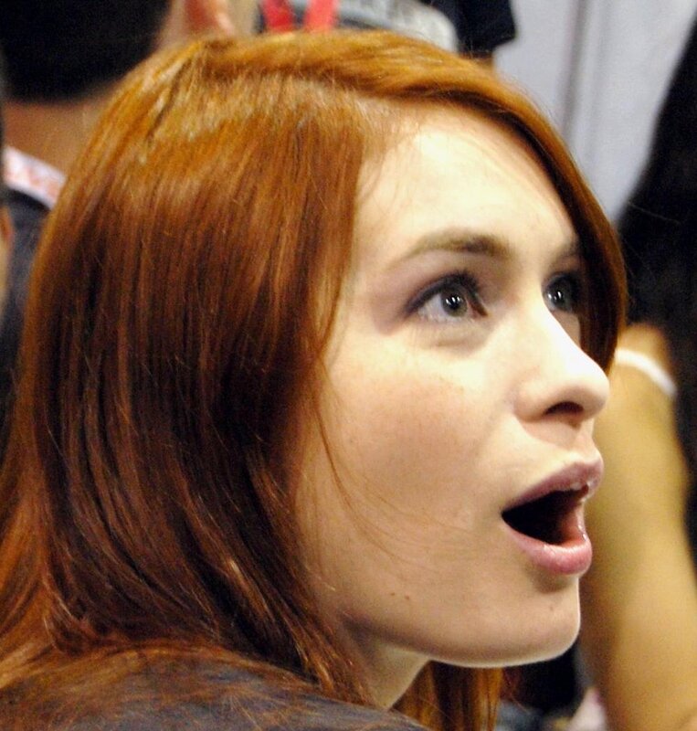 woman with red hair looking up
