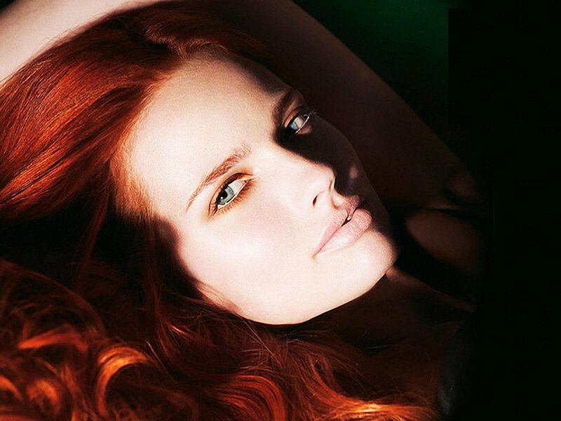 woman with red hair lying down