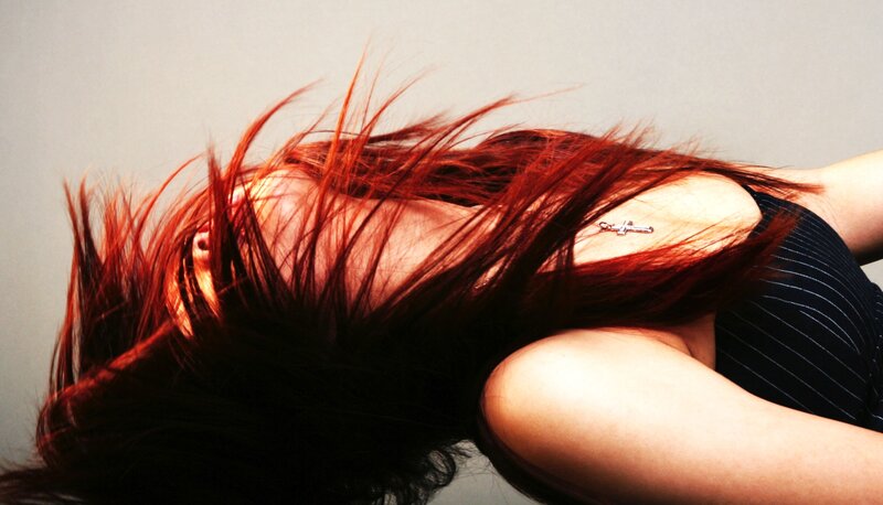 woman with red hair lying down
