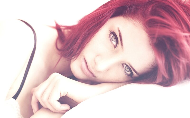 woman with red hair lying down