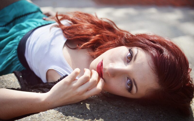 woman with red hair lying down