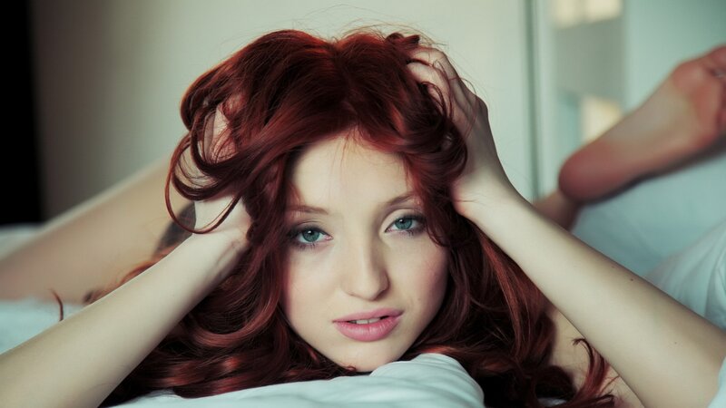 woman with red hair lying down