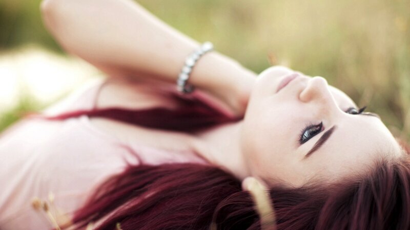 woman with red hair lying down