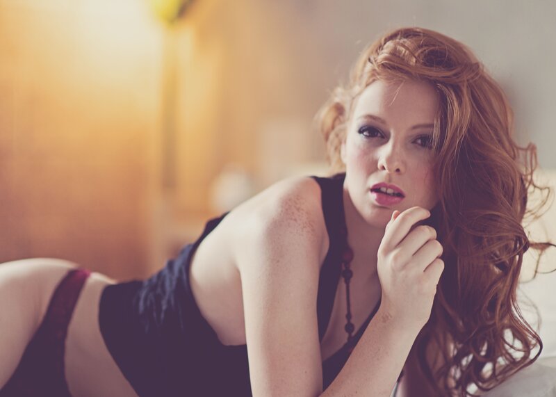 woman with red hair lying down