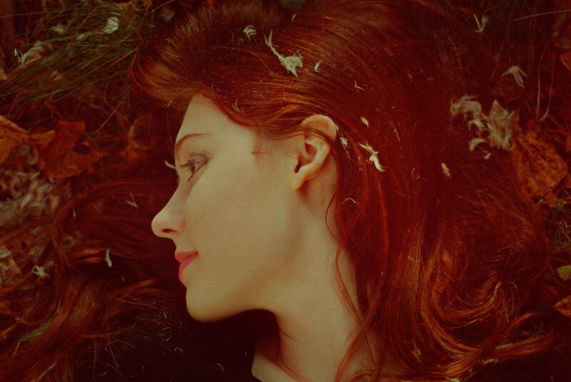 woman with red hair lying down