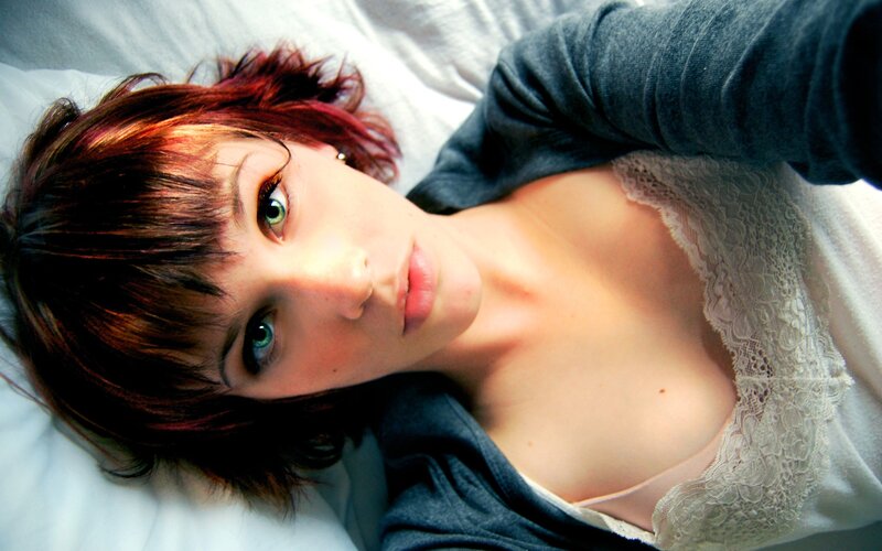 woman with red hair lying down
