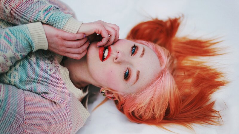 woman with red hair lying down
