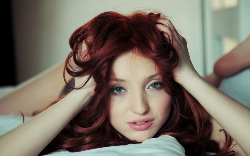 woman with red hair lying down