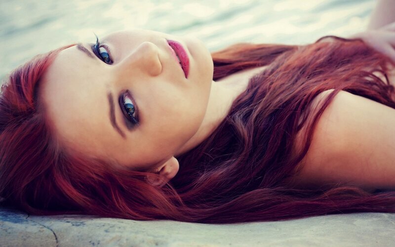 woman with red hair lying down