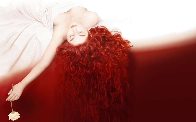 woman with red hair lying down
