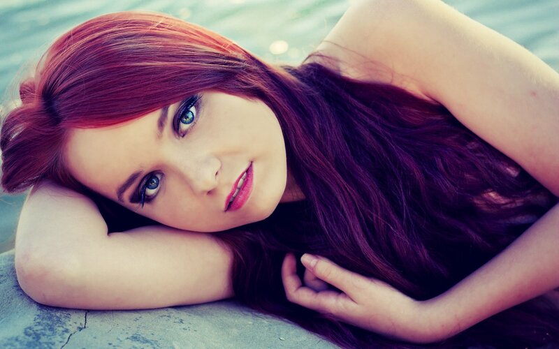 woman with red hair lying down