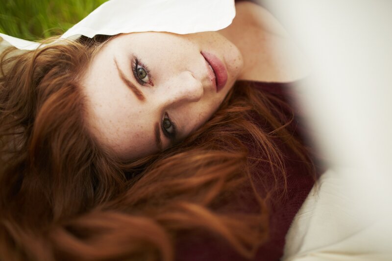 woman with red hair lying down