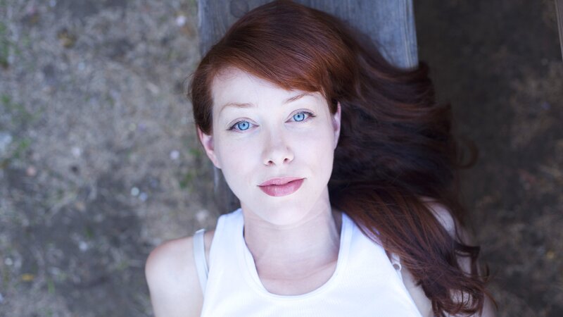 woman with red hair lying down