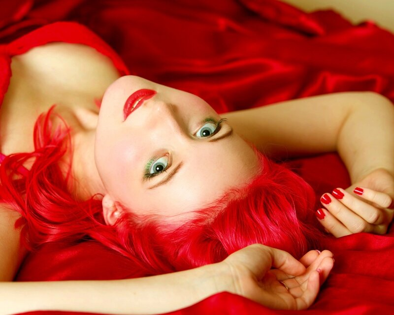 woman with red hair lying down