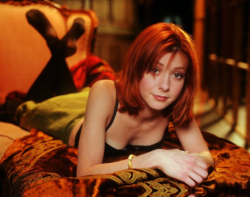 woman with red hair lying on bed