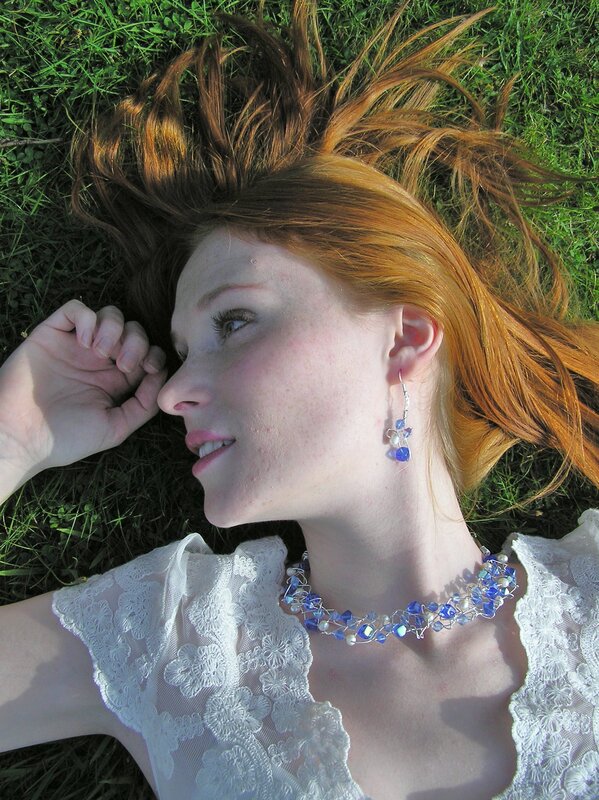 Woman with red hair lying on grass