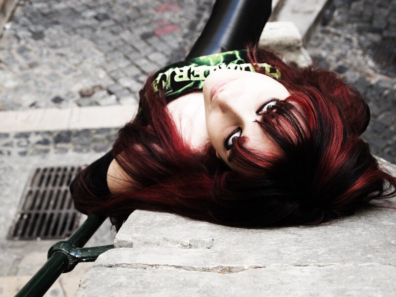 woman with red hair lying on steps
