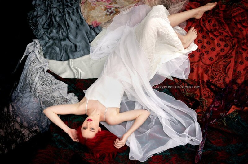 Woman with Red Hair Lying — White, Dramatic