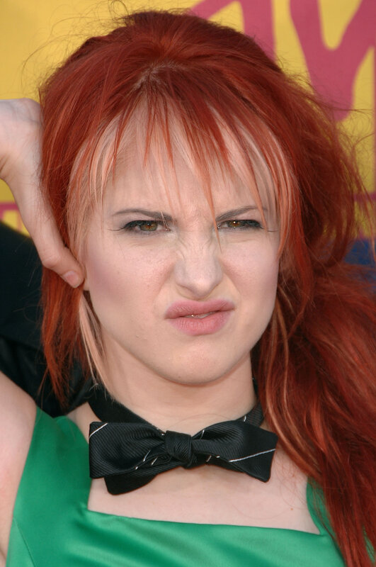 woman with red hair making a face