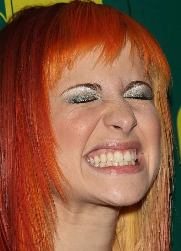 woman with red hair making a face